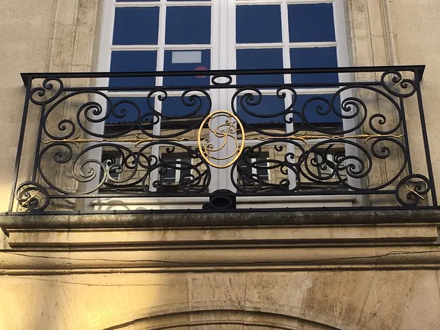 Balcon en fer forgé au chiffre doré, cours de l'Intendance